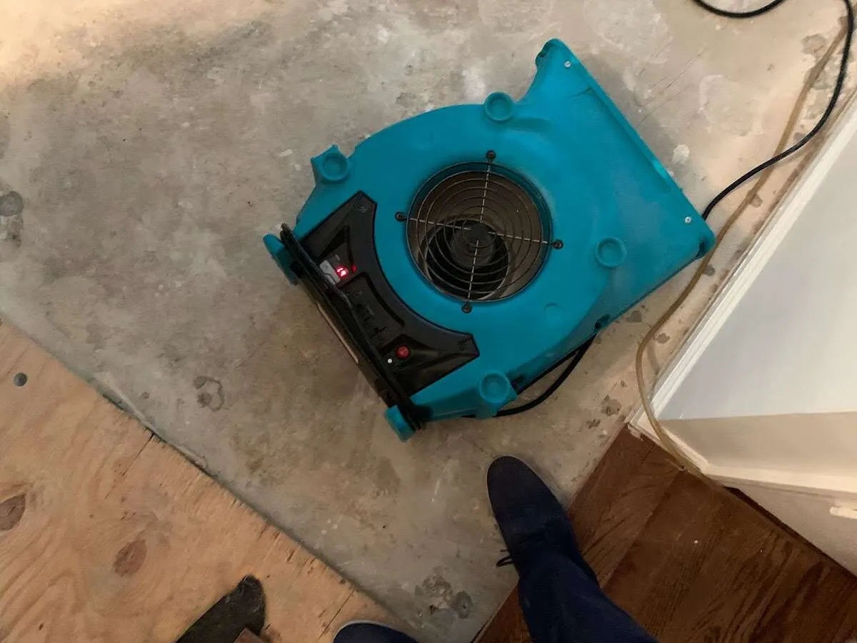 Air mover drying subfloor during Commercial Water Damage Restoration in Beachwood